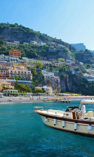 Caribbean Islands Explore the vibrant cliffs of Positano with a boat on blue waters, ideal for travel bliss.